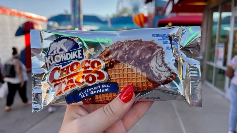 Hand holding a Klondike Choco Taco in its wrapper