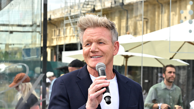 Gordon Ramsay speaking and holding a microphone