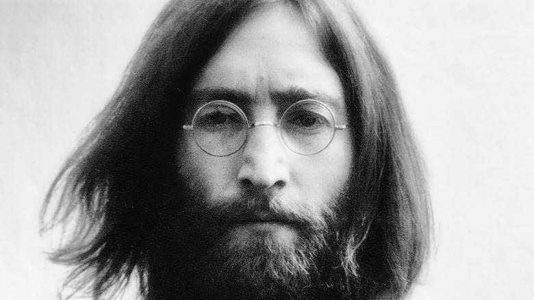 Black and white photograph of John Lennon's face looking into the camera