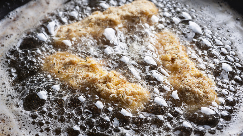 Chicken tenders frying in oil