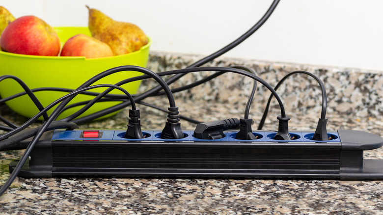 Power strip with cords plugged in on kitchen countertop