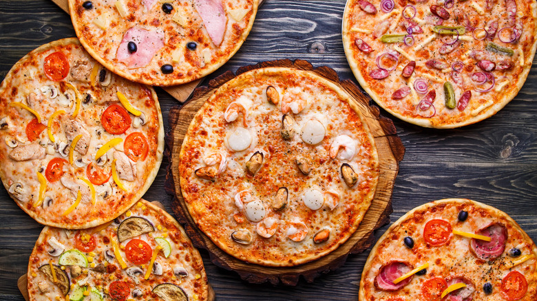 Whole pizzas on a table