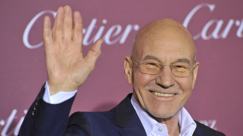 Patrick Stewart smiling and waving.