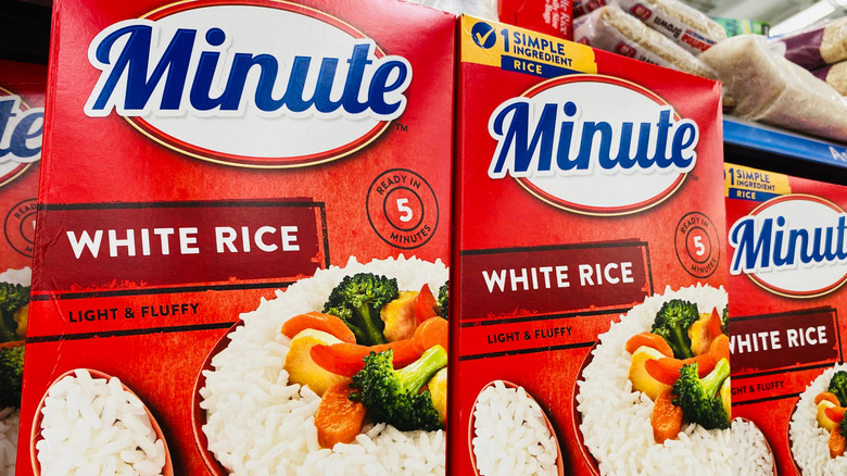 Boxes of Minute Rice stacked on a supermarket shelf.