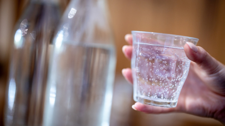 Person holding sparkling water