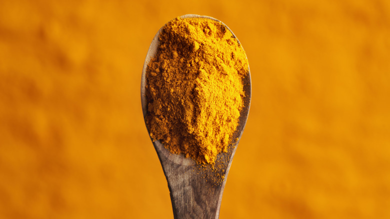Pile of turmeric powder on a spoon