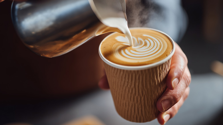 Close-up of barista making latte art