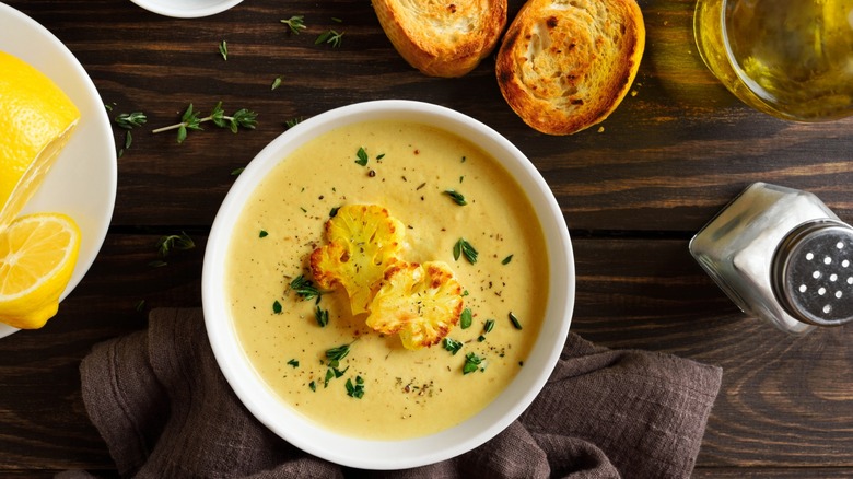 A bowl of cauliflower soup with crostini