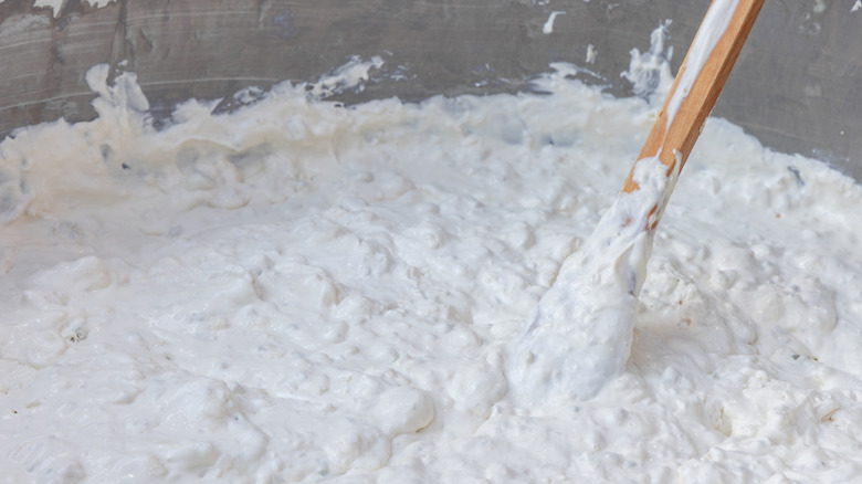 stracciatella being stirred with a wooden spoon
