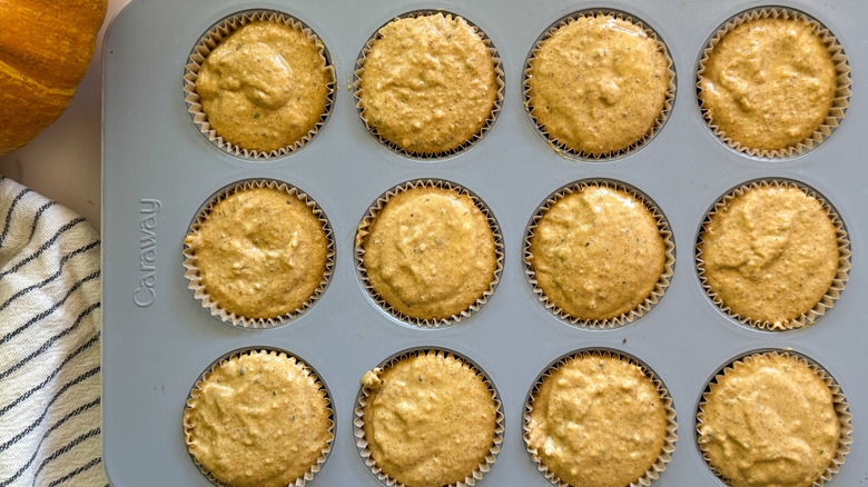 Unbaked pumpkin muffins in tin