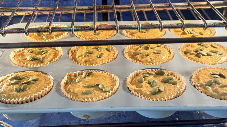 Pumpkin muffins in tin inside of oven