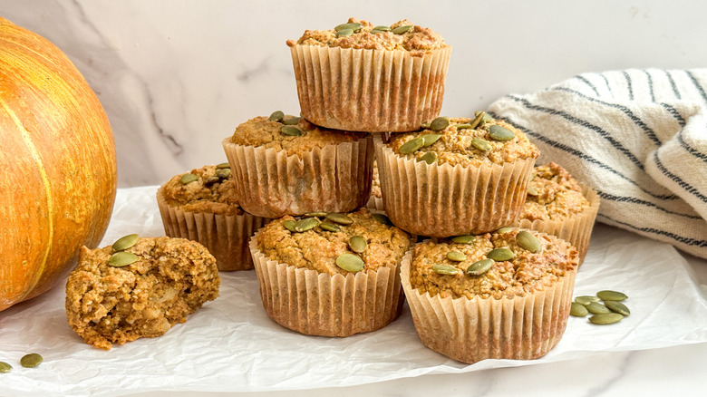 Pumpkin muffins stacked on parchment paper