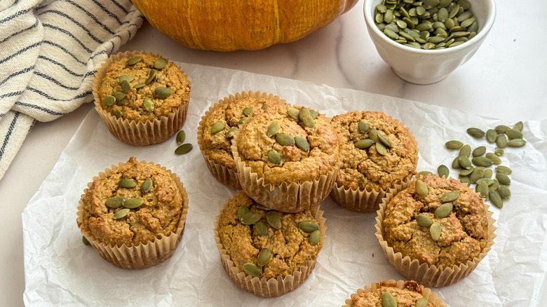 Pumpkin muffins stacked on parchment paper