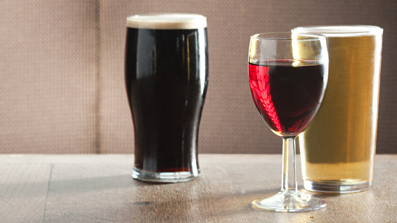 Glass of wine and pint of beer on a wood table