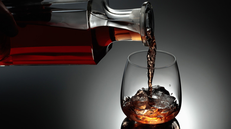 whiskey poured from decanter into glass