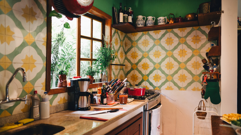 Vintage kitchen with patterned tile wall and various decorations