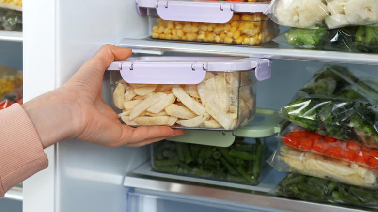 Person putting meal prepped food in the fridge