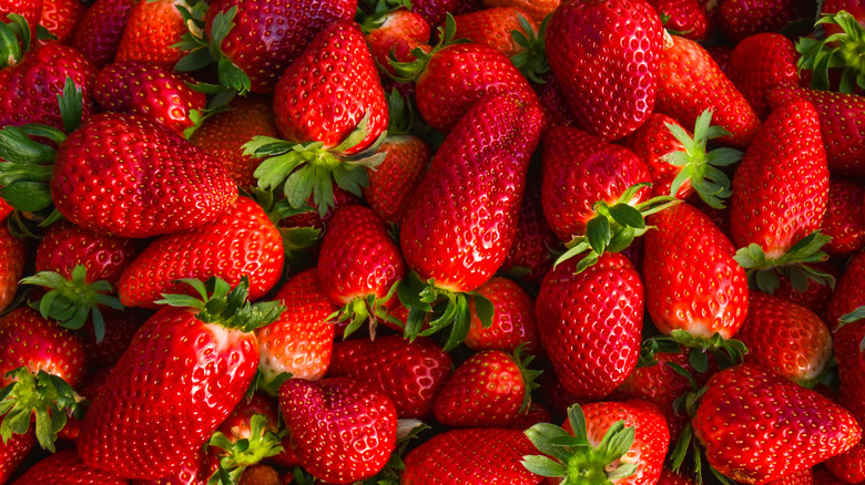 A pile of fresh, ripe strawberries.