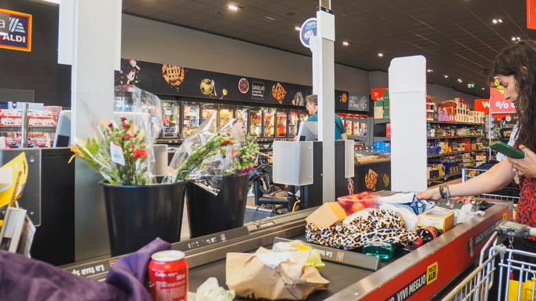 An Aldi shopper checking out
