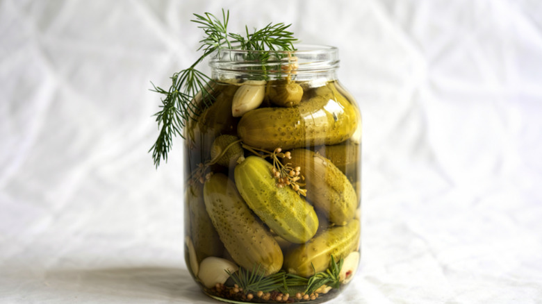 homemade pickles in a jar with herbs