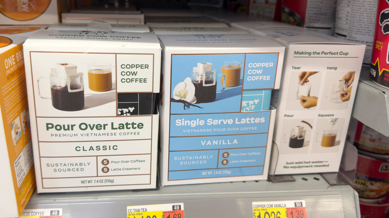 a shelf with copper cow coffee products