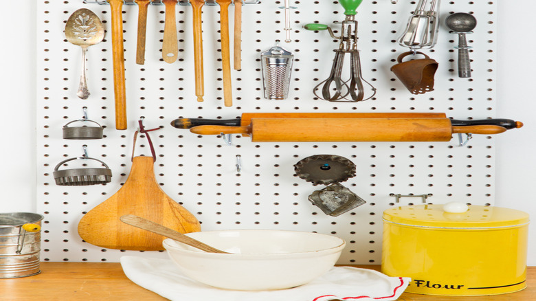 pegboard in a kitchen holding kitchen tools