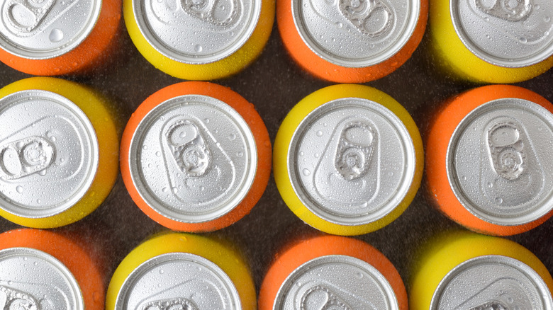 Top view of orange and yellow soda cans