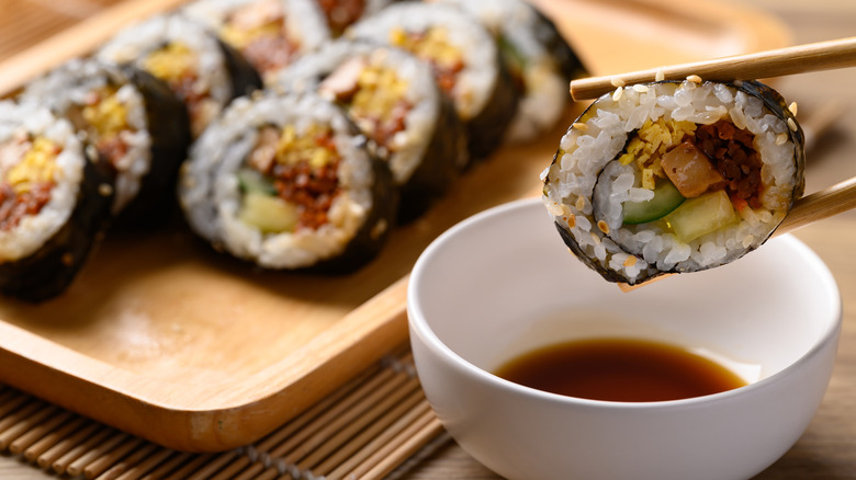 Slices of kimbap and soy sauce