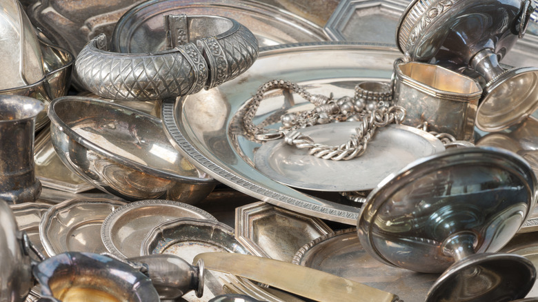 Pile of antique silver dishes and flatware