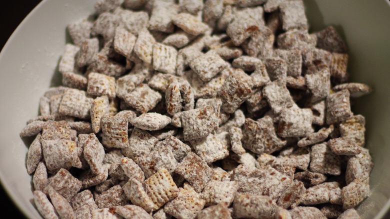 powdered sugar covered puppy chow in a bowl