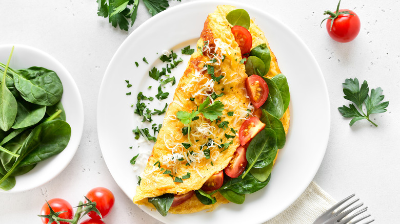 An omelet filled with tomatoes and spinach