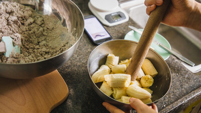 Person mashes bananas for banana bread