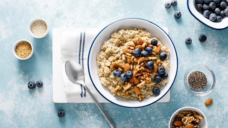 oatmeal with different toppings like blueberries, seeds, nuts