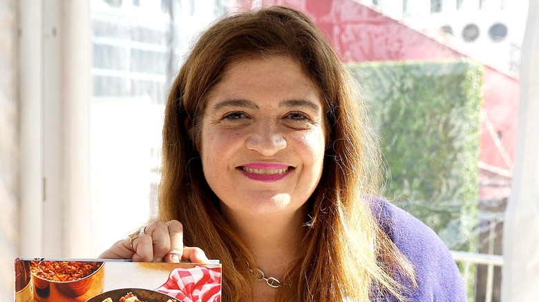 Alex Guarnaschelli smiling with teeth and pink lipstick