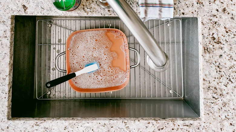 A soapy pot in a sink
