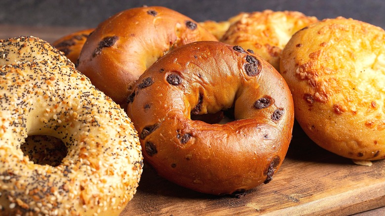 Everything, cinnamon-raisin, and cheese-covered bagels stacked together in rows