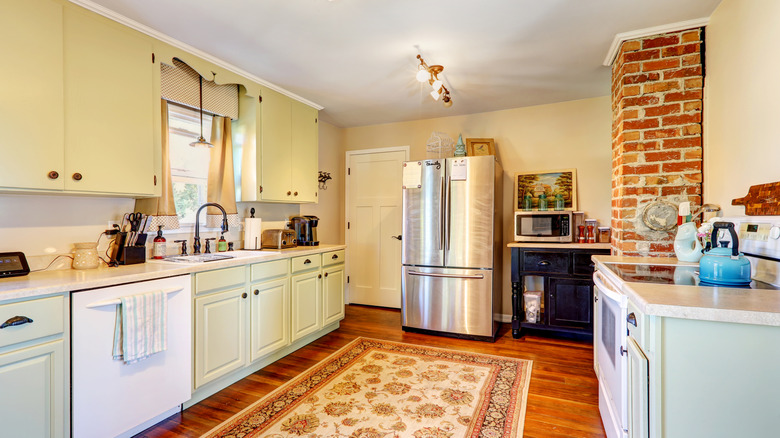 A warm, cozy kitchen with a patterned rug in the center