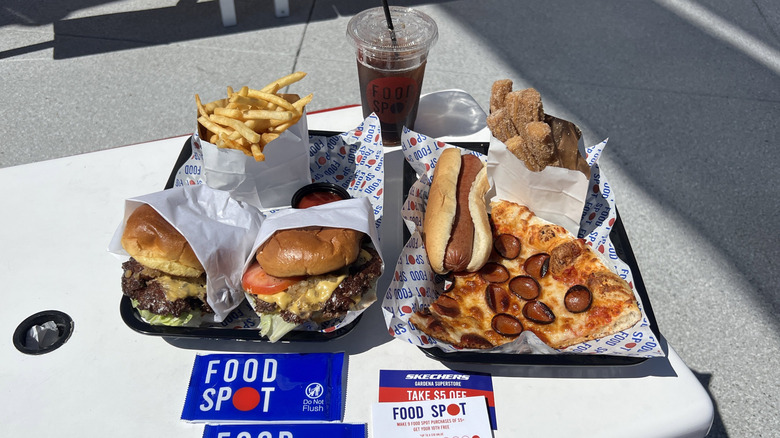 Items from Skechers' Food Spot, including pizza, hot dog, churros, burgers, fries, and a drink