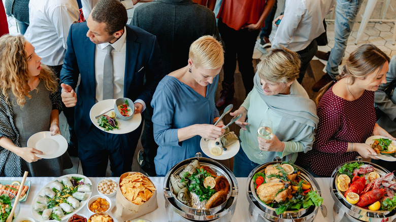 People serving themselves at a buffet