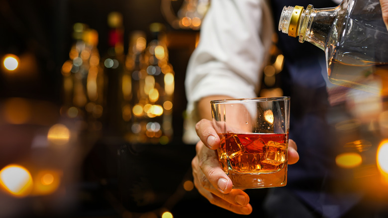 bartender serving whiskey