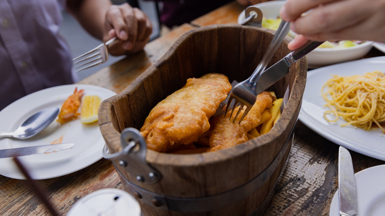 Fried fish and chips in wooden bucket