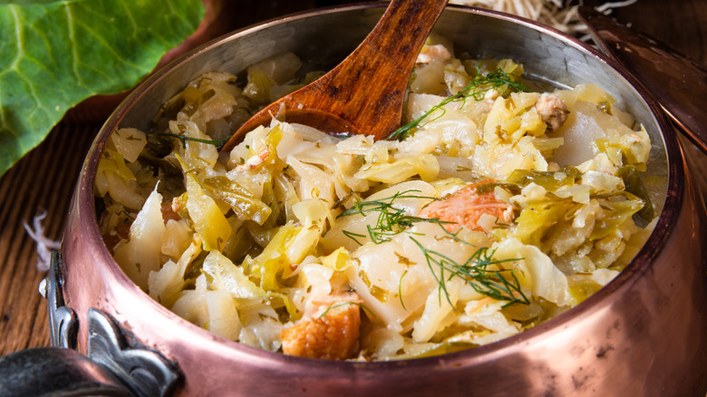 Fresh cabbage cooked in a metal pot.