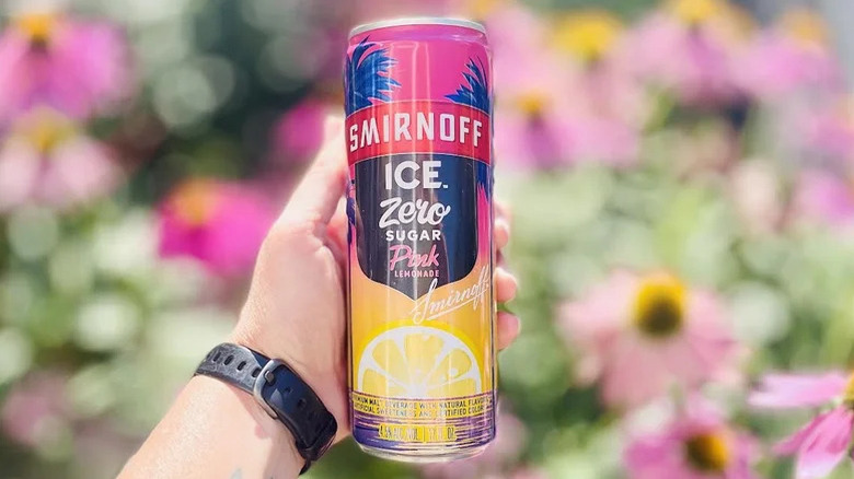 Hand holding a can of Smirnoff Ice