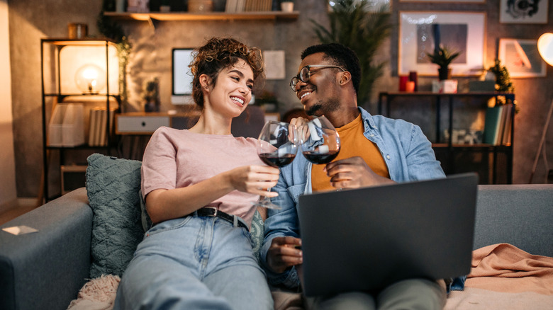 Young couple drinking wine on a couch