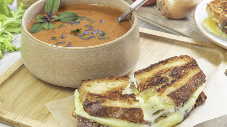 homemade grilled cheese next to a bowl of soup