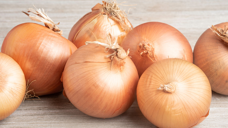 Vidalia onions on a wooden surface.