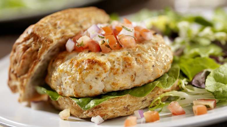 A turkey burger on a bun is pictured in close-up.