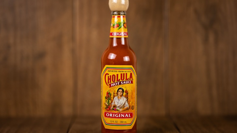 bottle of Cholula hot sauce on table