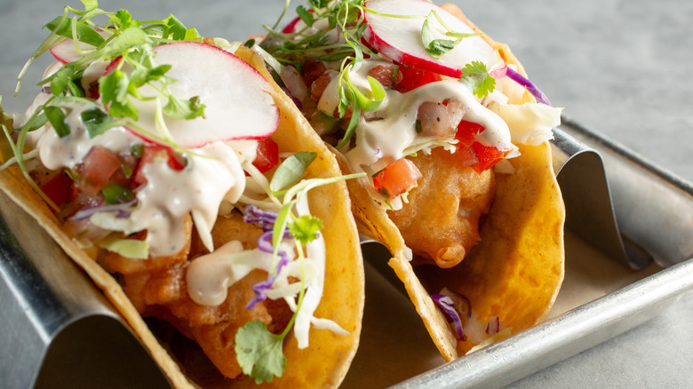 Two crunchy fish tacos with sauce