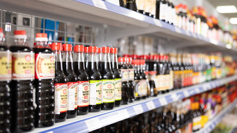 Shelf of soy sauce bottles.